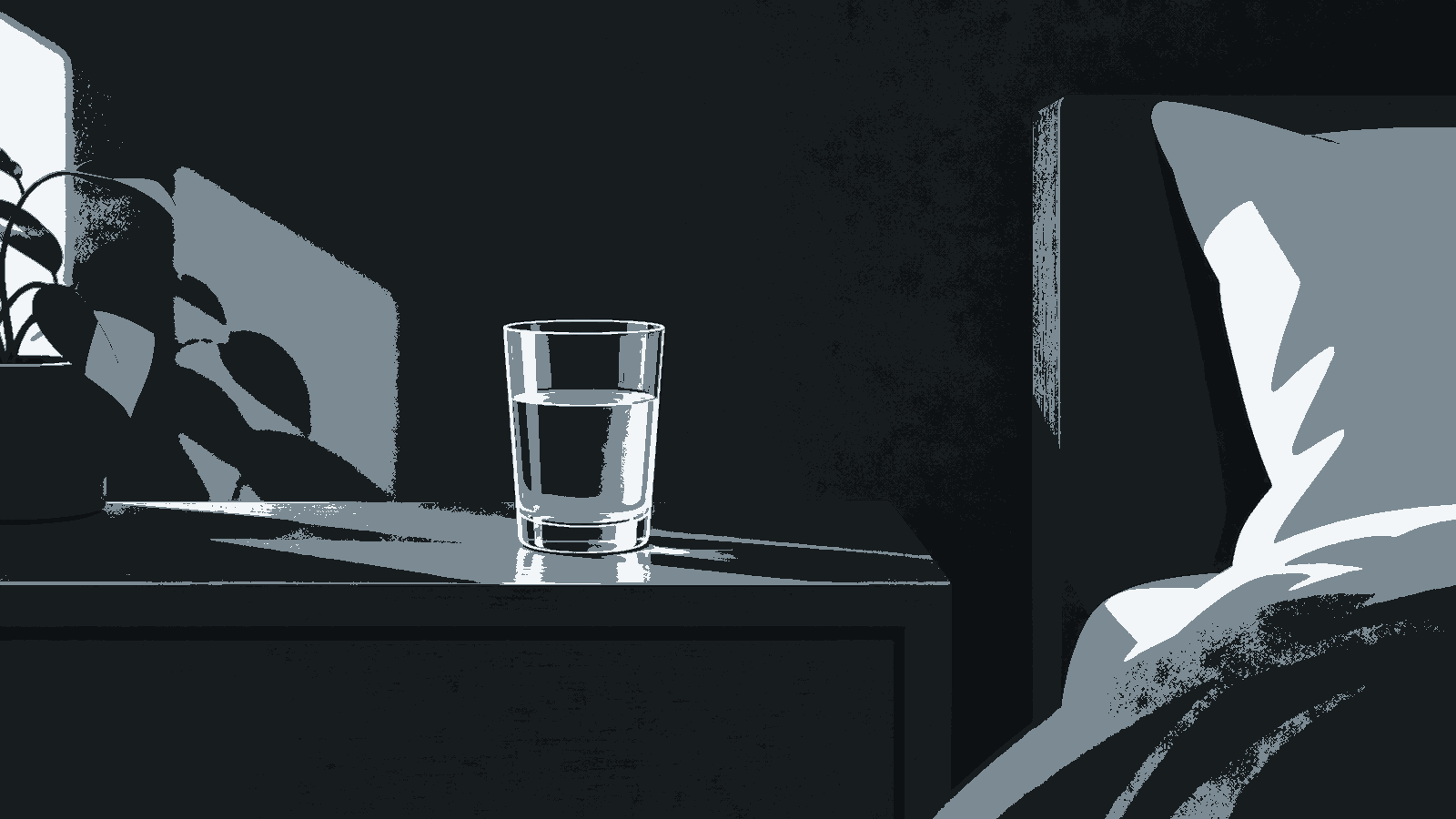 A glass of water sits on a nightstand in morning light beside the edge of a bed.