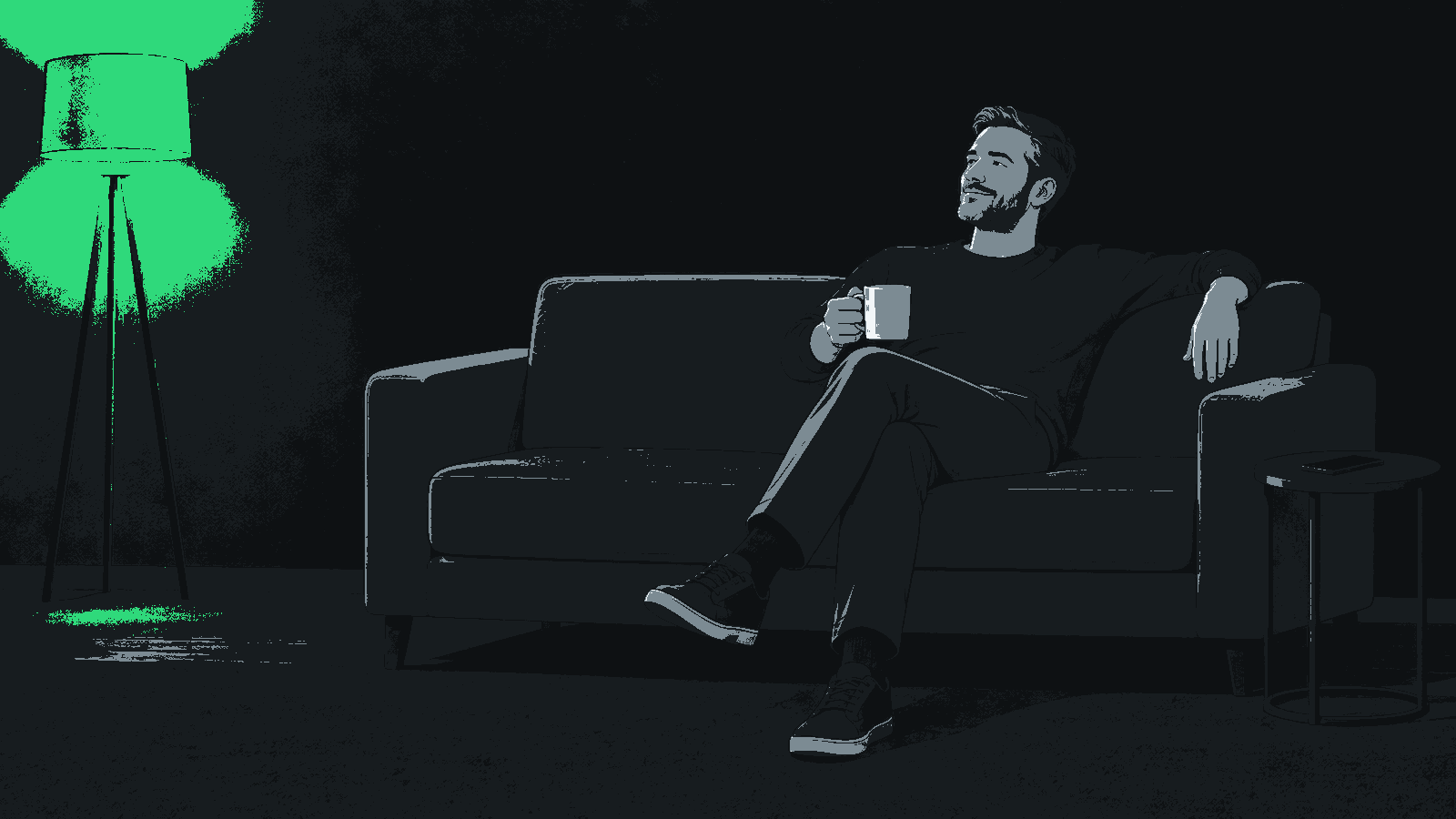 A fully clothed man rests on a sofa holding a mug, with a phone face down on a side table and a lamp glowing green.